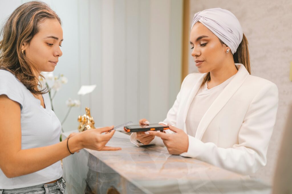 Woman paying with credit card on a beauty clinic